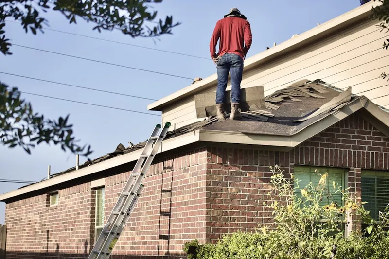 Professional roofer working on a residential roof in Old Mill Estates